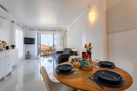 You'll love the dining room with its four-seat wooden table, the fully equipped kitchen with its white cabinets, and the lovely living room with its balcony.