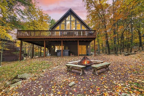 Charming exterior under the golden sky featuring a fire pit.