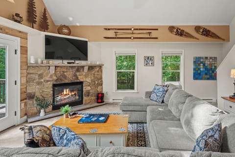 This cozy living room exudes warmth and comfort, perfect for relaxing by the fireplace.