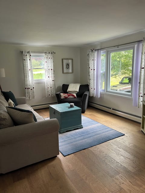 Living room with comfy seating and TV for streaming. 
