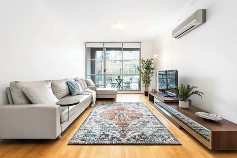 A spacious living area with a 5-seater L-shaped couch