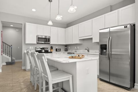 modern kitchen with white cabinetry and stainless steel appliances