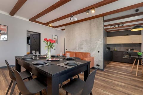 Welcoming dining area with wooden flooring, open layout and warm brick elements.