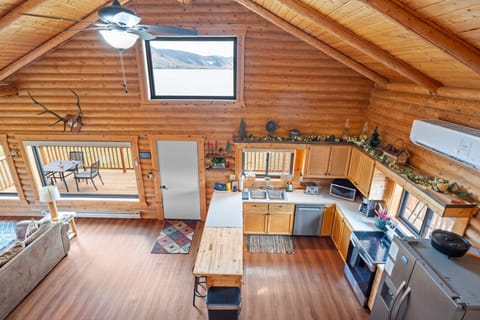 Stunning view from the loft overlooking the open kitchen, living, and dining space.
