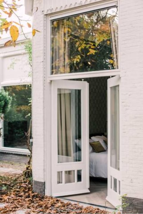 A beautiful, spacious window that opens to the outdoors, where you can enjoy a peaceful view of the garden area. The large windows provide ample natural light and an open, airy feel to the interior space.