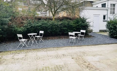 Outdoor seating area with charming chairs, perfect for enjoying a quiet moment in the fresh air.