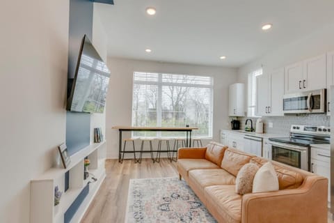 The open main floor features a kitchen, living area, and TV wall that makes group gathering seamless.