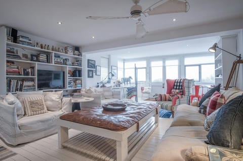 Large foot stool/table with leather cushion. White painted wooden floor