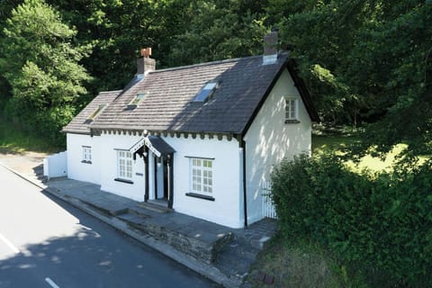 The outside of Garden Cottage with steps up to the cottage from the road