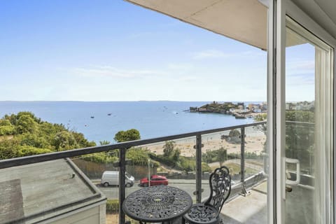 Coastal view of Tenby from an apartment balcony with outdoor table set