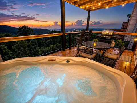 Soak in the hot tub while enjoying breathtaking Smoky Mountain sunset views.