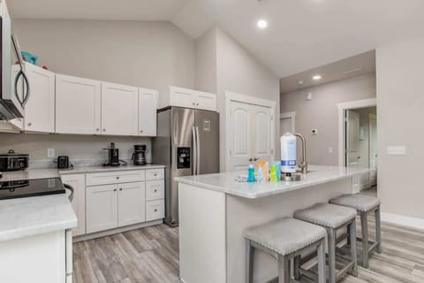 Full living room, with flat screen TV. Perfect for family vacations, or a couples getaway. Couch and loveseat. and living room attached to a kitchen with Island.