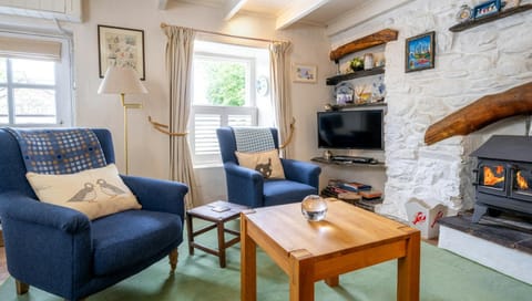 Two arm chairs, coffee table and electric woodburner effect fire