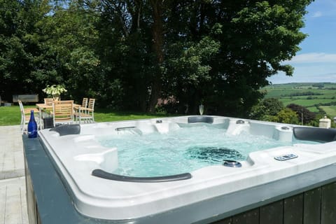 Hot tub in the garden with picnic table and chairs