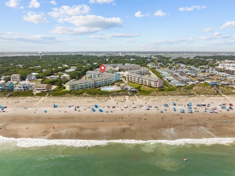 Aerial view of beachfront property complex with direct beach access and oceanfront location.