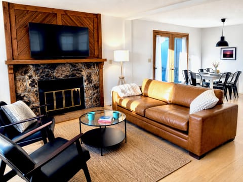 Relax with family and friends in the spacious living space with electric fireplace, smart TV, and sunny dining area