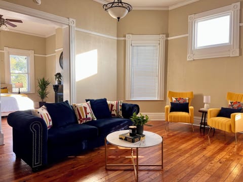 Living space with blue couch and yellow chairs