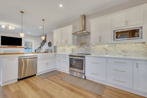 Plenty of cabinet space underneath a new quartz countertop and stainless steel appliances