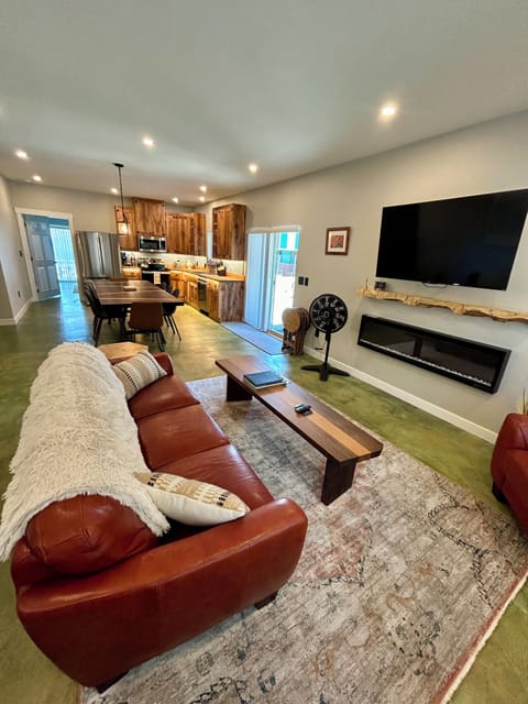 First floor living room with dining area and kitchen in backround