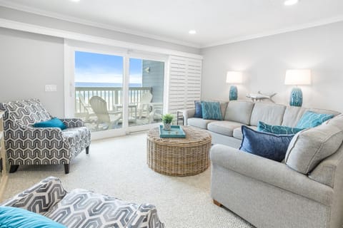 Sink into coastal comfort with plush seating and ocean breezes flowing through your bright living space.