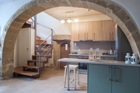 Well-Designed Kitchen with Staircase to Upper Level