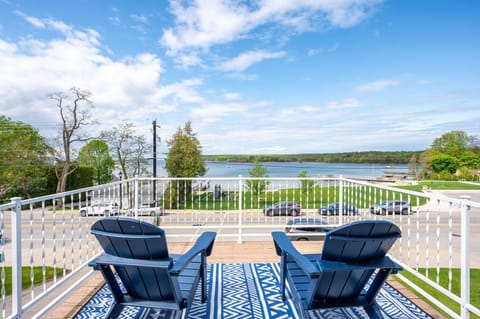 Located just off of the upstairs primary bedroom, the upper deck offers stunning water views.