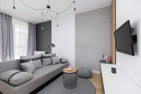 A unique living room with a practical kitchenette.