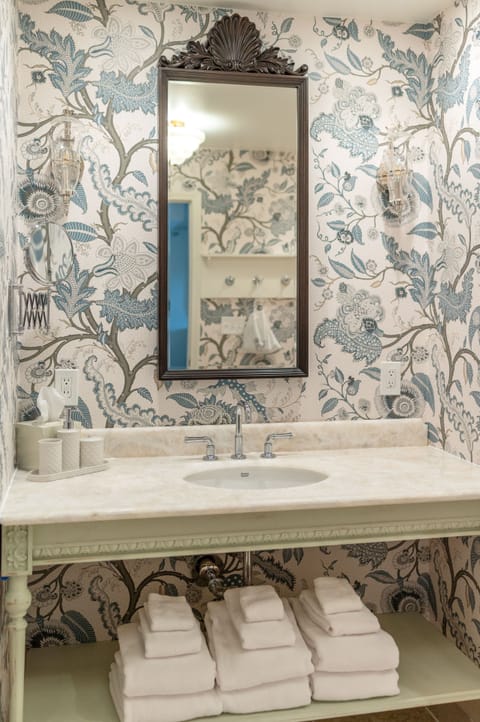 Charming details and soft textures invite you to refresh in a space where calm meets character.