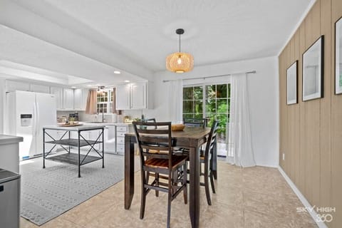 Spacious dining area just off the kitchen features seating for 4 and warm pendant lighting—ideal for group meals.