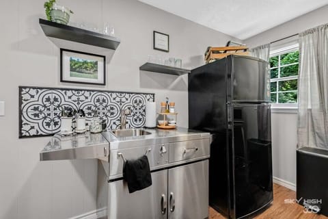 Second kitchenette with sink, fridge, and bar area—perfect for mixing drinks and preparing snacks.