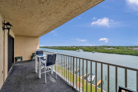 Relax on the covered balcony w/ comfy seating and calming water views stretching into the distance.