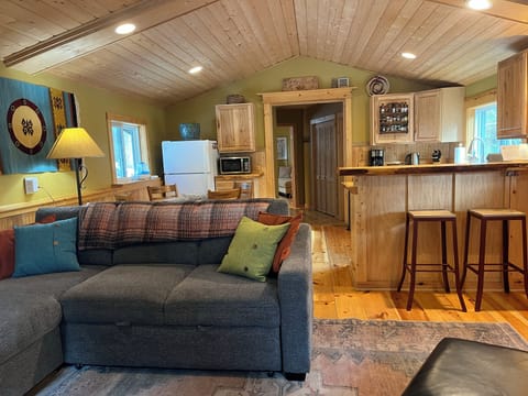 Relax in this charming open-concept space where rustic wood meets modern comfort—your perfect mountain retreat awaits.