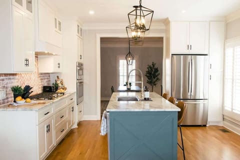 Bright kitchen perfect for cooking and gathering, with island and appliances.