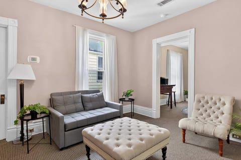 Living Room: Relax in this cozy living room featuring comfortable seating, warm lighting, and the perfect space to unwind after a day of exploring or traveling.