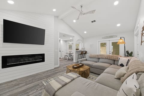 Sink into plush sectional seating in this bright, open living area where vaulted ceilings and a sleek fireplace create the perfect backdrop for your downtime together.