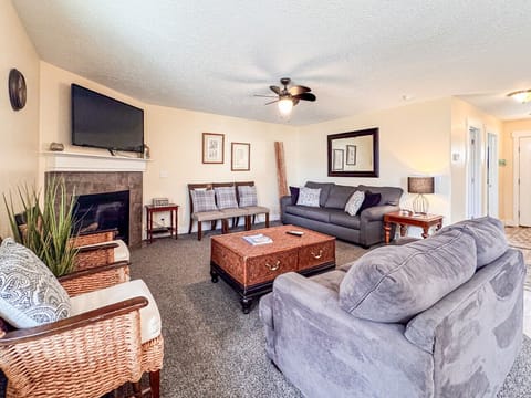 Cozy Living room with plush seating, warm fireplace, and natural light—perfect for relaxing or entertaining.