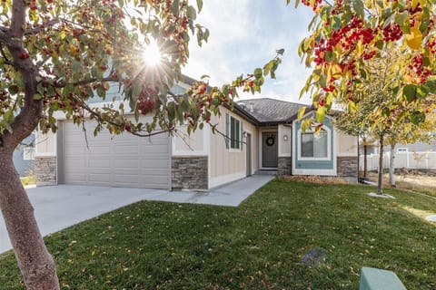 Charming home with a cozy front porch, beautiful landscaping, and welcoming neighborhood