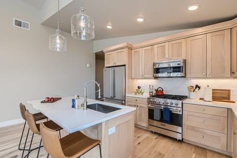 Prepare a gourmet meal in this chef-inspired kitchen featuring sleek quartz countertops and a spacious island with seating.
