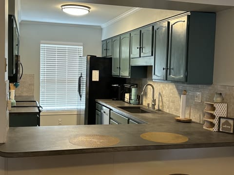 Stocked kitchen: coffee pot, Keurig, waffle iron, pots, pans & baking needs.