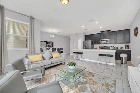 Kick back in the spacious living room with comfortable furniture, a large flat-screen TV, and complimentary high-speed Wi-Fi for the ultimate vacation experience.