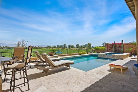 Bar stools in the pool let you sip drinks while watching golf—fairway views from the water daily.