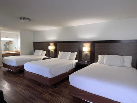 Family Room, 3 Queen Beds  | Iron/ironing board, free cribs/infant beds, rollaway beds, free WiFi