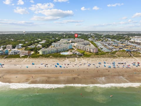 Beachfront resort complex with direct beach access and multiple buildings surrounded by coastal community.