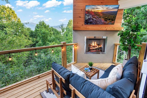 Cozy up by the outdoor fireplace on the top deck, where you can take in the stunning mountain views and breathe in the fresh air.