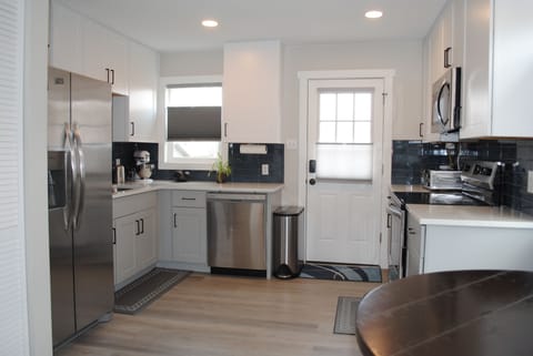 Full kitchen with stainless steel appliances.