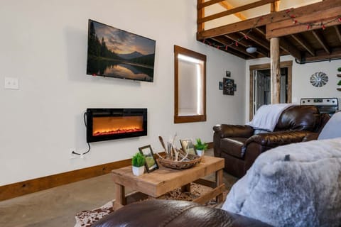 Curl up by the fireplace and enjoy movie nights together in this cozy, inviting living space.