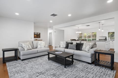 From the plush grey sofas to the chef’s kitchen, this bright, interconnected space is designed for modern living and entertaining.