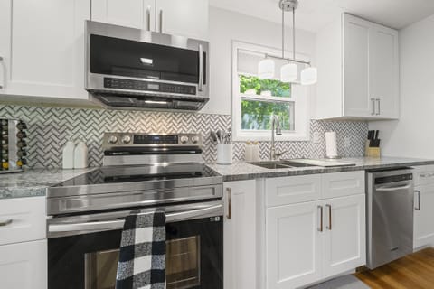 Cottage A- All brand new appliances accompanied by white cabinets and drawers.