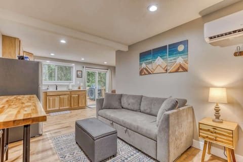 Cozy, modern retreat with full kitchen, comfy sofa, and forest views—perfect for relaxing after exploring!