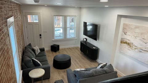 Living room area with a 65 inch smart tv.
